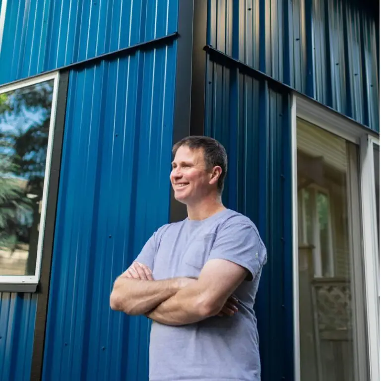 Sean Moloughney stands out front of a shed he just built